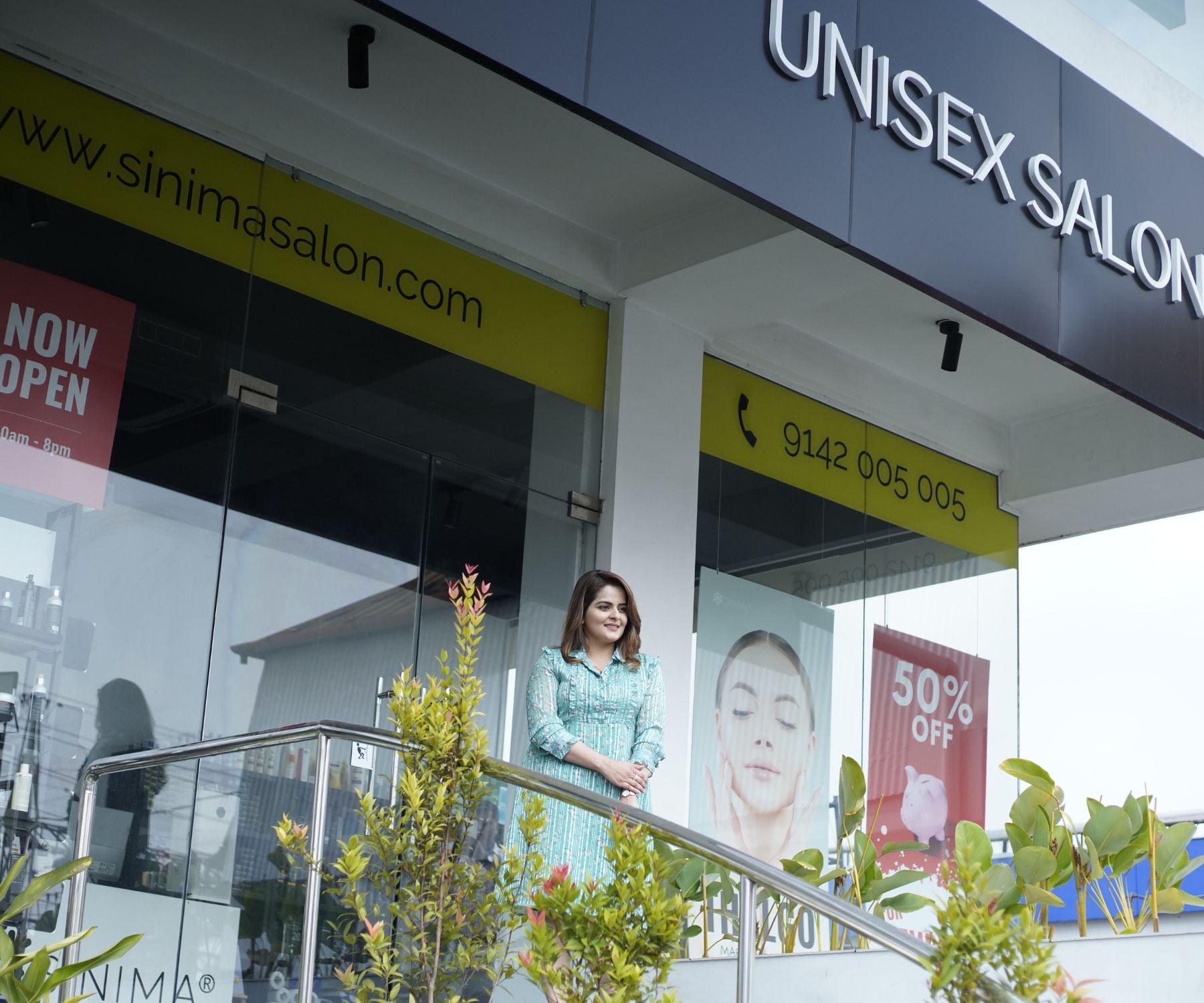 SINIMA Salon entrance with a actress Roma standing outside.